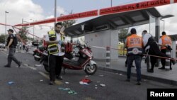 Israeli emergency personnel stand at the scene of a stabbing in Jerusalem, Oct. 8, 2015. A Palestinian stabbed and wounded a Jewish seminary student on a main road in Jerusalem on Thursday and the assailant was arrested at the scene, police said. 