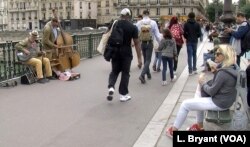 People listening to street musicians in Paris.