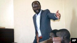 FILE - South Sudanese academic and activist Peter Biar Ajak, gestures during his trial in the capital Juba, South Sudan, March 25, 2019.