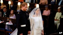 Britain's Prince Harry and Meghan Markle stand, prior to the start of their wedding ceremony, at St. George's Chapel in Windsor Castle in Windsor, near London, England, May 19, 2018. 