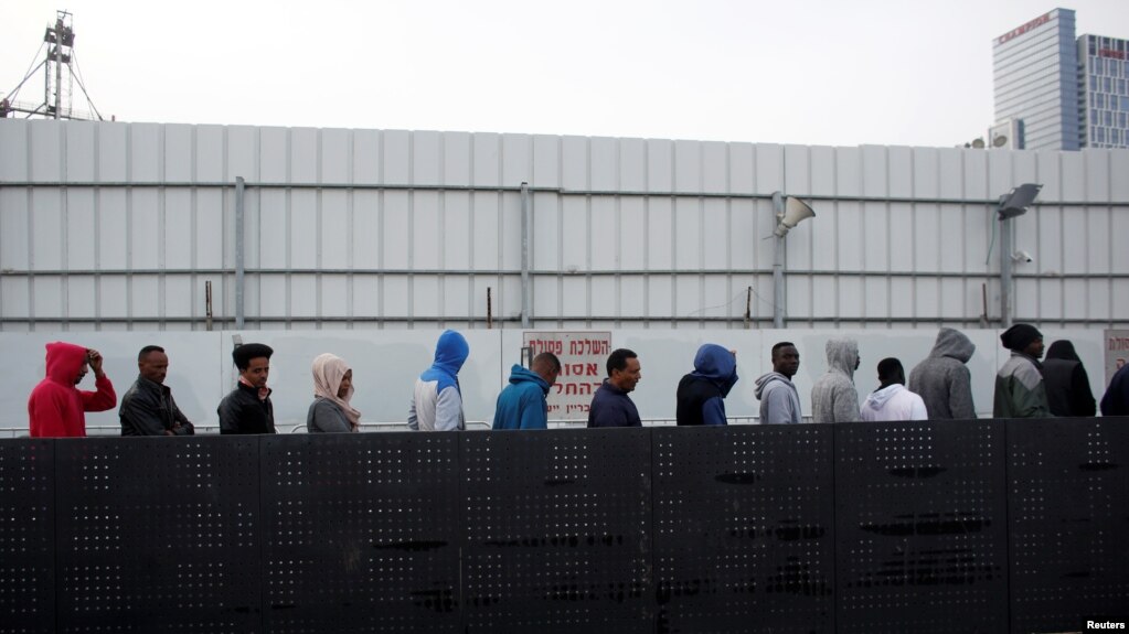 African migrants wait in line for the opening of the Population and Immigration Authority office in Bnei Brak, Israel, Feb. 4, 2018. 