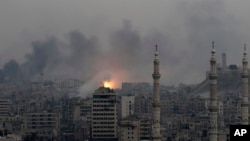 A ball of fire rises following a Syrian government air strike that hit rebel positions in the eastern neighborhoods of Aleppo, Syria, Dec. 5, 2016. 