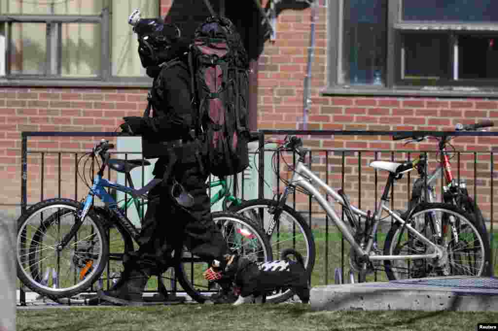 A man and his dog go for a walk, with both wearing protective clothing during the global outbreak of the coronavirus disease (COVID-19) in Toronto, Ontario, Canada, April 6, 2020.