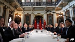 FILE - U.S. and Chinese delegations meet in the Indian Treaty Room in the Eisenhower Executive Office Building on the White House complex, during continuing meetings on the U.S.-China bilateral trade relationship, Feb. 21, 2019, in Washington.