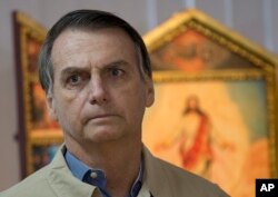 FILE - Presidential candidate Jair Bolsonaro is pictured during a meeting with Rio de Janeiro's Archbishop Dom Orani Tempesta in Rio de Janeiro, Brazil, Oct. 17, 2018.