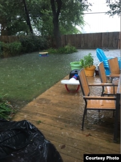 Floodwaters rise to meet the deck in the backyard of a home in the Westbury neighborhood of Houston, Aug. 27, 2017. (Photo courtesy of Paul Trinh)