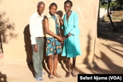 Anna Lungisani poses with father and sister, wearing clothes donated by Marvelous-Mhlanga Nyahuye