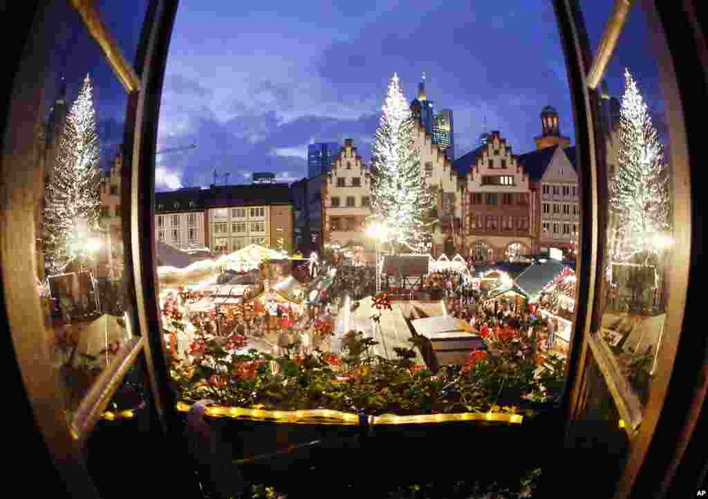 The Christmas tree of the Christmas Market is reflected in two windows in downtown Frankfurt, Germany.