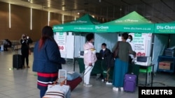 Passengers queue to get a PCR test against the coronavirus disease (COVID-19) before traveling on international flights, at O.R. Tambo International Airport in Johannesburg, South Africa, Nov. 26, 2021.