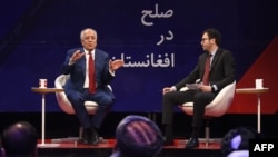 U.S. special representative for Afghan peace and reconciliation Zalmay Khalilzad, left, gestures as he speaks during a forum with Afghan director of TOLO news Lotfullah Najafizada at the Tolo TV station in Kabul, April 28, 2019.