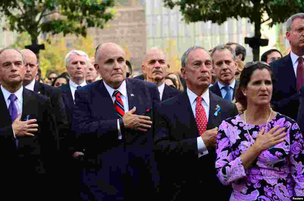 Former Mayor Rudy Giuliani (2nd L) and New York City Mayor Michael Bloomberg (2nd R) attend a ceremony at the 9/11 Memorial marking the 12th anniversary of the attacks on the World Trade Center in New York September 11, 2013.