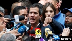 Venezuelan opposition leader and self-proclaimed interim president Juan Guaido accompanied by his wife Fabiana Rosales, speaks to the media in Caracas, Jan. 27, 2019.
