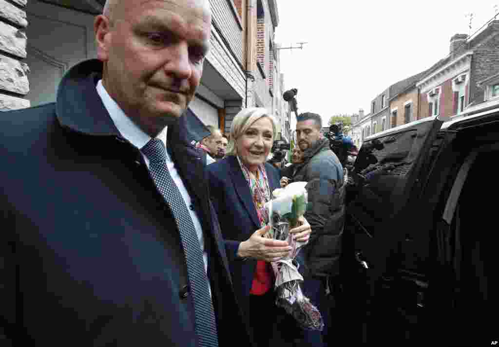French far-right presidential candidate Marine Le Pen leaves Henin Beaumont, on her way back to Paris after casting her ballot, May 7, 2017.