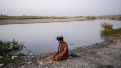 A Taliban member offers prayer on the banks of a river in Kandahar, Sept. 23, 2021.