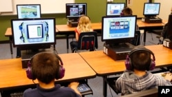 In this July 21, 2014 file photo, students at a summer reading academy at Buchanan elementary school work in the computer lab at the school in Oklahoma City. (AP Photo/Sue Ogrocki,File)