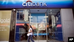 A woman walks by a Citibank branch in Buenos Aires, Argentina, March 17, 2015.