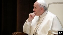 Pope Francis meets a group of children who traveled on a special train from Milan and arrived at St. Peter's station at the Vatican, June 9, 2018 as part of an initiative to give children living in disadvantaged areas of the country a day of joy. 