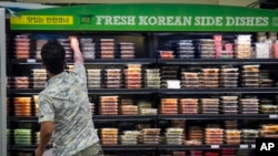 FILE - A man reaches for a food item at the Super H Mart Asian grocery in Fairfax, Virginia, July 20, 2015.