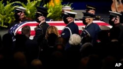 A military honor guard carries the flag-wrapped coffin of former Senate Majority Leader Harry Reid during a memorial service at Smith Center in Las Vegas, Saturday, January 8, 2022.