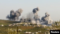 FILE - Smoke rises after what activists said was an airstrike on Atimah, Idlib province, March 8, 2015. 