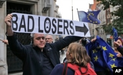 Pro-EU membership supporters argue with a leave campaigner outside the High Court, on the second day of the lawsuit of Gina Miller, a founder of investment management group SCM Private in London, Oct. 17, 2016.