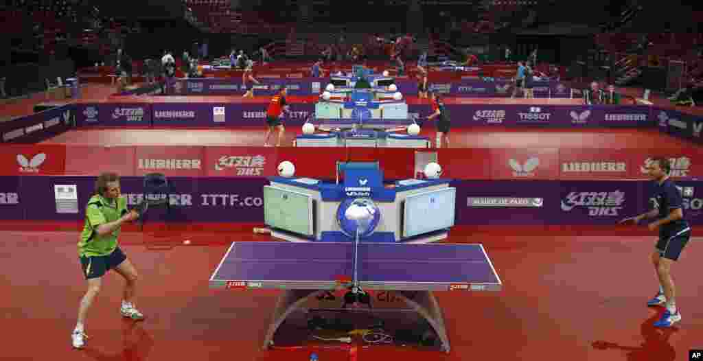 Competitors in the World Table Tennis Championships train at the Bercy stadium, Paris. 