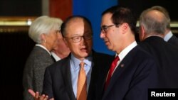 El presidente del Banco Mundial, Jim Yong Kim, habla con el Secretario del Tesoro de Estados Unidos, Steven Mnuchin, mientras Christine Lagarde, Directora Gerente del Fondo Monetario Internacional, camina detrás de ellos luego de la foto oficial en la Reunión de Ministros de Finanzas del G20 en Buenos Aires, Argentina, 21 de julio de 2018 . REUTERS / Marcos Brindicci.