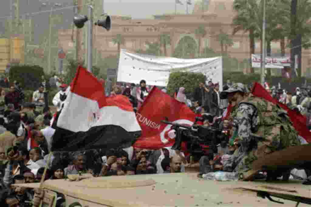 An Egyptian army soldier watches thousands of Egyptians gather at Cairo’s Tahrir Square. February 25, 2011 (AP Photo/Amr Nabil)