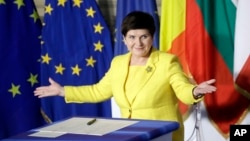 Polish Prime Minister Beata Szydto gestures after signing a declaration during an EU summit meeting at the Orazi and Curiazi Hall in the Palazzo dei Conservatori in Rome, March 25, 2017.