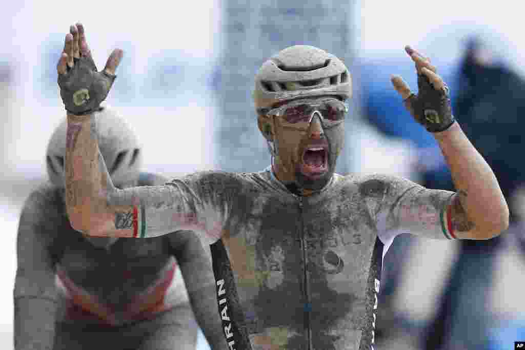 Sonny Colbrelli of Italy celebrates as he crosses the finish line ahead of Florain Vermeersch of Belgium, rear and second place, to win the men&#39;s Paris Roubaix, a 258 kilometer (160.3 miles) one-day-race cycling race, at the velodrome in Roubaix, northern France.