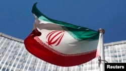 FILE - An Iranian flag flutters in front of the United Nations headquarters in Vienna, June 17, 2014. 