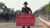 Policeman stands behind a banner reading "if this line is crossed, Myanmar police force will fire with live ammunition" during a protests against the military coup and to demand the release of elected leader Aung San Suu Kyi. (File)