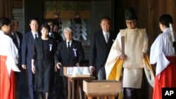 Japanese lawmakers visit the Yasukuni Shrine to pay respect to the war dead on the day of the 69th anniversary of the end of the World War II, in Tokyo , Friday, Aug. 15, 2014.