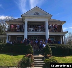 Members of Delta Kappa Epsilon pose with friends outside their fraternity house near the campus of Virginia Tech in Blacksburg, Va.