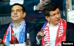 Greek Prime Minister Alexis Tsipras (L) and Turkish Prime Minister Ahmet Davutoglu watch the soccer match Nov. 17, 2015, between Turkey and Greece in Istanbul.