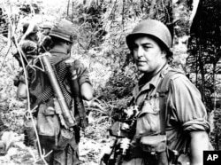 FILE - Associated Press photographer Horst Faas on assignment with soldiers in South Vietnam.