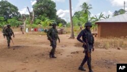 FILE - Rwandan soldiers patrol in the village of Mute, in Cabo Delgado province, Mozambique, Aug. 9, 2021, in this image made from video. 
