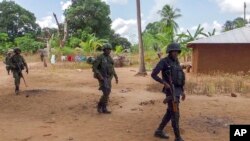 FILE - Rwandan soldiers patrol in the village of Mute, in Cabo Delgado province, Mozambique, Aug. 9, 2021.