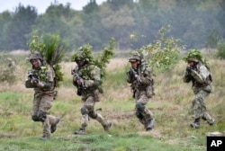 File - soldiers take part in exercises at the yvoryev military training ground near lviv in western ukraine on september 24, 2021, as part of a joint exercise between the us, other nato countries and ukraine.