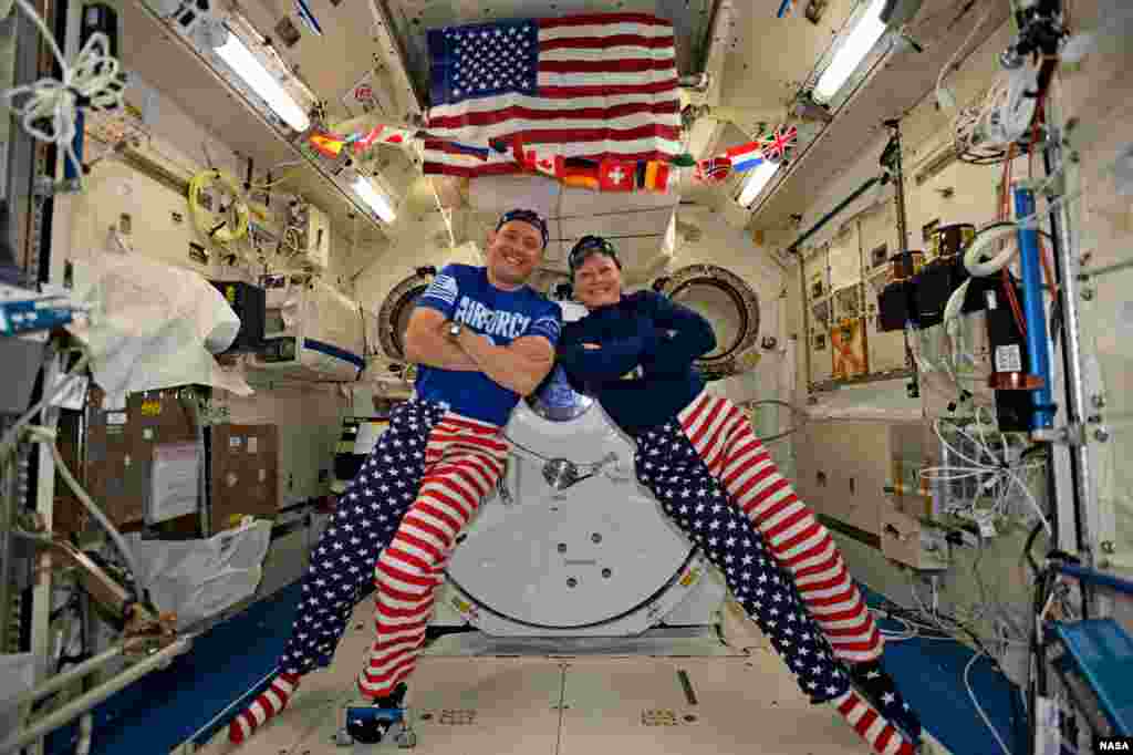 NASA astronauts Jack Fischer and Peggy Whitson celebrate the Fourth of July from over 250 miles above Earth on the International Space Station. Fischer shared this photo on social media and said, &quot;We sometimes have issues standing up straight, but we have no problems at all showing our American pride-Happy 4th!&quot;