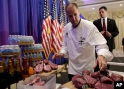 A chef with the Trump National Golf Club arranges Trump steaks for a display prior to a scheduled news conference by Republican presidential candidate Donald Trump, March 8, 2016, in Jupiter, Florida.
