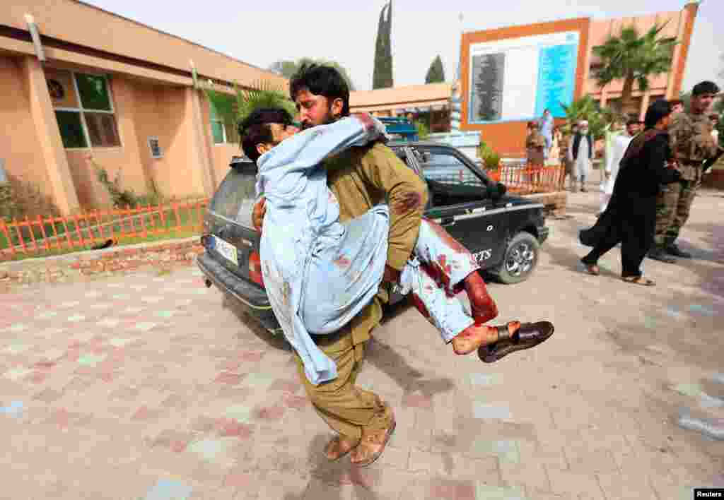 An injured man is carried to a hospital after a car bomb in Jalalabad city, Afghanistan.