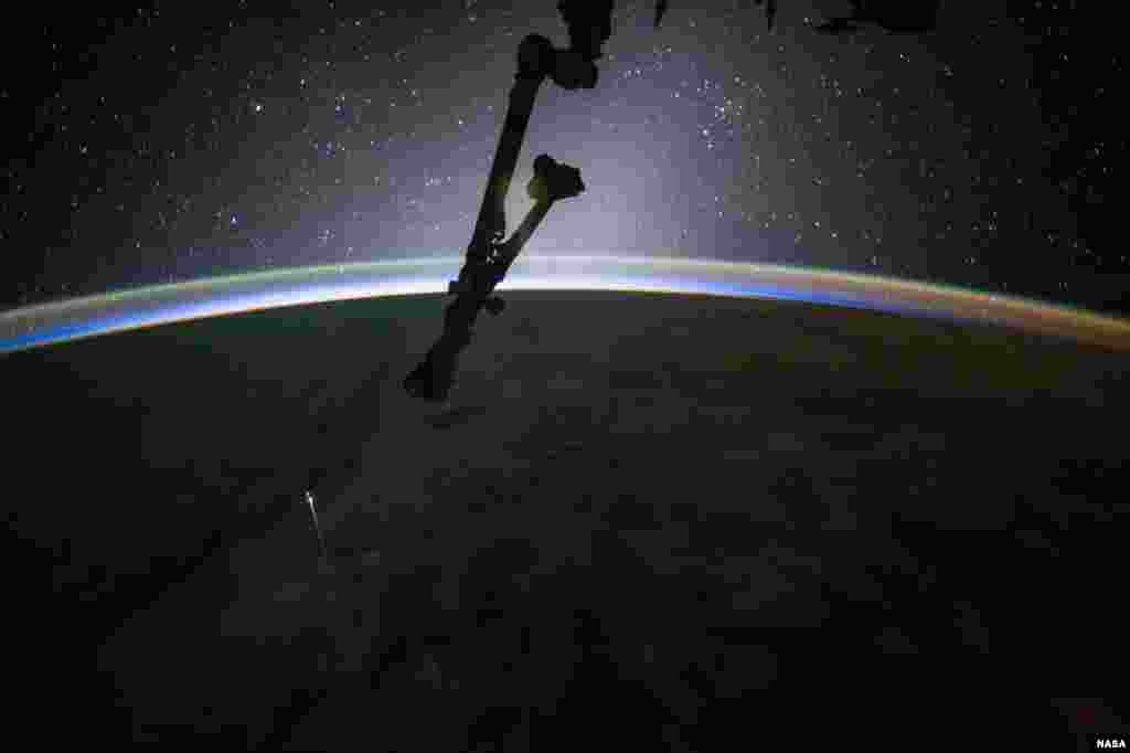 NASA astronaut Jack Fischer photographed the SpaceX Dragon capsule as it reentered Earth's atmosphere before splashing down in the Pacific Ocean west of Baja California at 8:12 a.m. EDT, July 3, 2017. Fischer commented, "Beautiful expanse of stars-but the “long” orange one is SpaceX-11 reentering!"