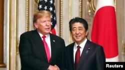 Poignée de mainentre le Président des États-Unis, Donald Trump et le Premier ministre japonais Shinzo Abe avant leur déjeuner de travail au Akasaka guesthouse à Tokyo, au Japon, le 27 mai 2019.