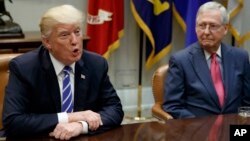 Senate Republican Majority Leader Mitch McConnell, right, listens as President Donald Trump speaks during a meeting with Congressional leaders and administration officials, in the Roosevelt Room of the White House, in Washington, Sept. 5, 2017. 