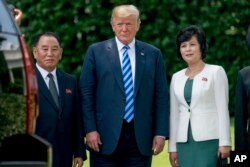 FILE - From left, former North Korean military intelligence chief Kim Yong Chol, President Donald Trump, and Kim Song Hye, head of the Committee for the Peaceful Reunification of Korea of the Korean Workers' Party, pose for a photograph outside the Oval Office.