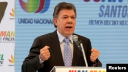 FILE - Colombian President Juan Manuel Santos, shown campaigning in April 2014, says the suspension of air raids against FARC forces will continue because they've maintained their cease-fire.