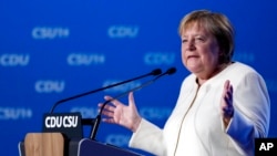 German Chancellor Angela Merkel gestures during her speech at a state election campaign in Munich, Germany, Sept. 24, 2021, two days before Sunday's general election. 