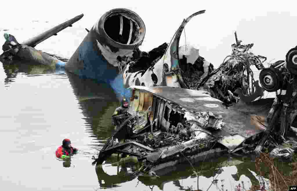 September 7: Rescue divers work next to the wreckage of a plane that crashed near the Russian city of Yaroslavl. A passenger plane carrying a Russian ice hockey team crashed after takeoff from a provincial airport, killing 43 people. REUTERS/Maxim Shipenk