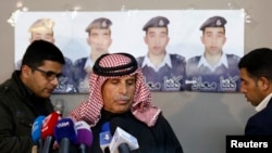 Safi al-Kaseasbeh, center, father of Islamic State captive Jordanian pilot Mu'ath al-Kaseasbeh, stands before a news conference where he asked Islamic State fighters to pardon and release his son, in Amman, Feb. 1, 2015. 